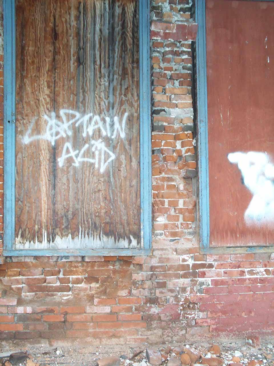 Hornell Erie Depot before restoration with boarded up windows and crumbling brick walls, graffiti