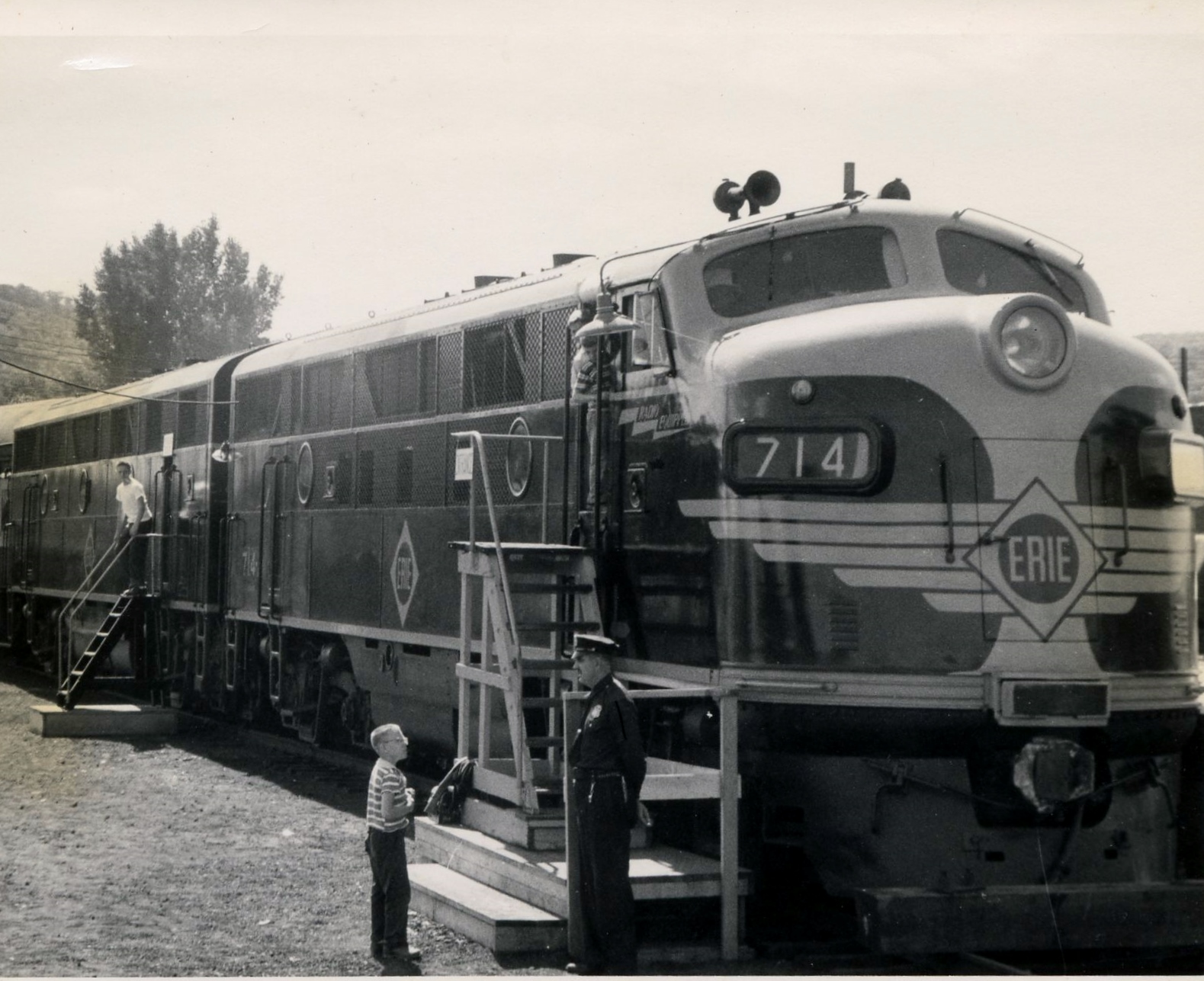 Erie train black and white photo with man standing next to tain