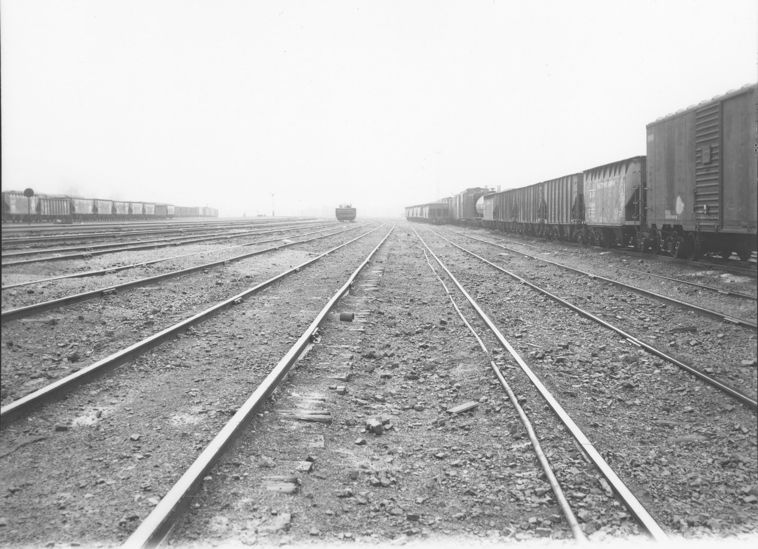 black and white photo of trains on tracks